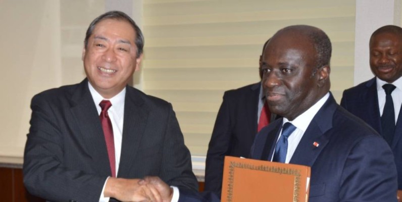 Échange de parapheurs entre Marcel Amon-Tanoh (à droite) et l’ambassadeur du Japon. (Julien Monsan)