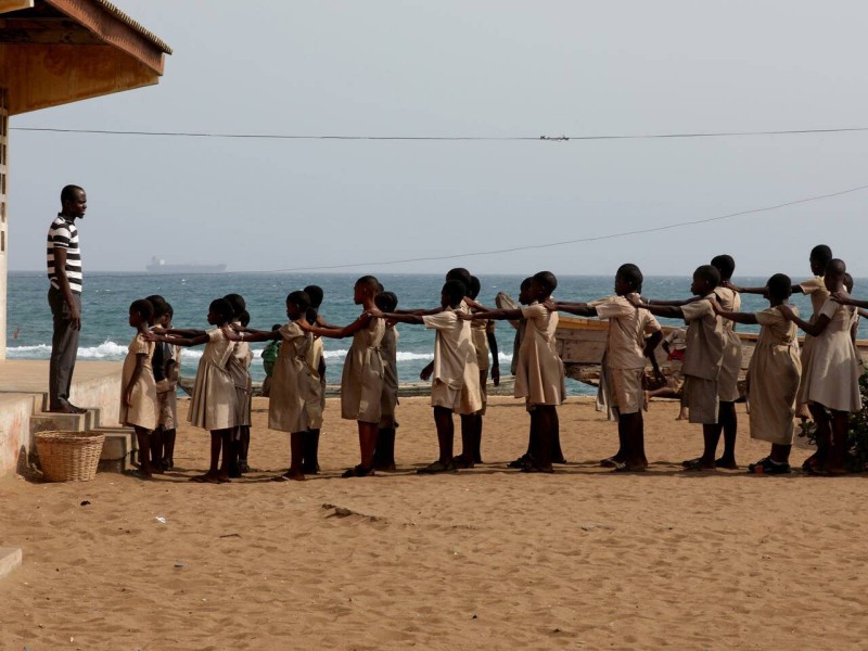 Pupils line up in the yard of their school, which, according to head teacher Hlongnoin Akouavi, was damaged by sea storms and is under threat from coastal erosion, in Baguida, a suburb of Lome, Togo, February 24, 2020. Picture taken February 24, 2020. REUTERS/Luc Gnago     TPX IMAGES OF THE DAY