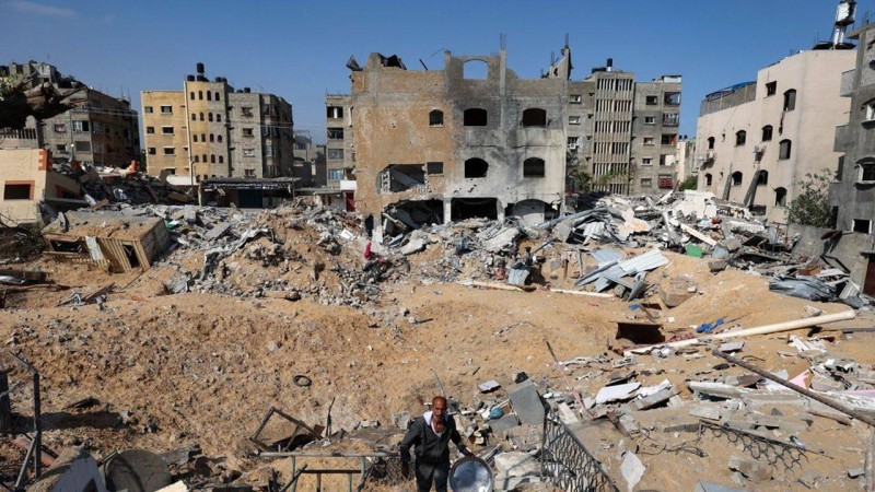 A Palestinian man walks amidst rubble from buildings damaged during Israeli bombardment, in Beit Lahia in the northern Gaza Strip, on May 20, 2021. - Israel and the Palestinians are mired in their worst conflict in years as Israel pounds the Gaza Strip with air strikes and artillery, while Hamas militants fire rockets into the Jewish state. (Photo by Mohammed ABED / AFP)
