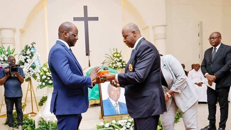 Le Grand chancelier Ally Coulibaly (à droite) remettant le coffret de l'insigne à un proche du défunt. (Ph: Sercom Grande chancellerie)