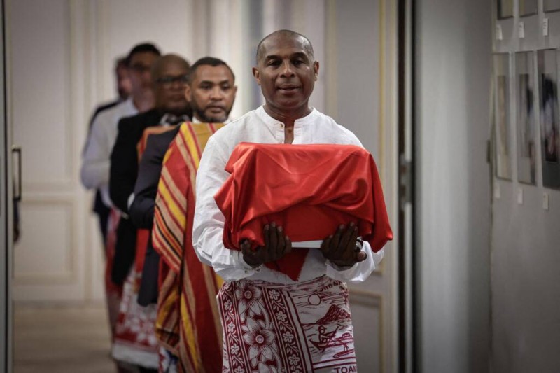  Un homme portant l'un des trois crânes sakalava lors d'une cérémonie de restitution à Madagascar, au ministère de la Culture à Paris, le 26 août 2025. AFP - STEPHANE DE SAKUTIN 
