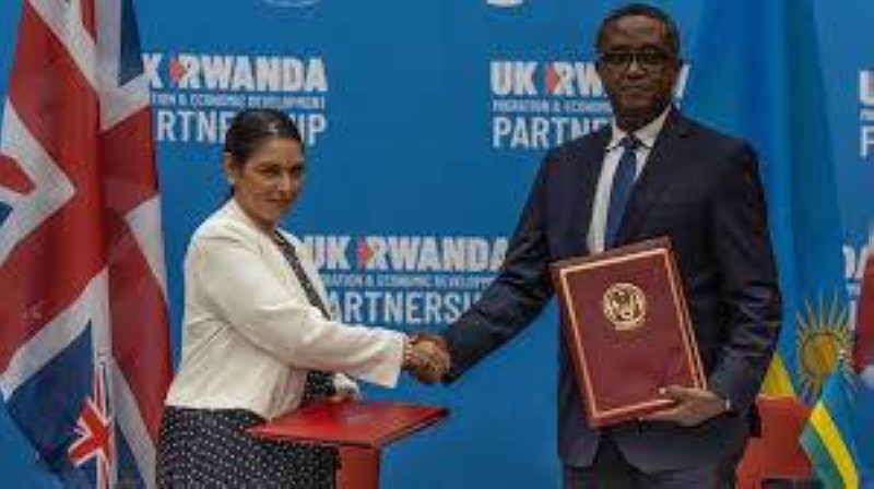 La ministre britannique de l'Intérieur, Priti Patel (g), et le ministre rwandais des Affaires étrangères et de la Coopération internationale, Vincent Biruta, se serrent la main après la signature d'un accord au Centre des congrès de Kigali, Kigali, Rwanda, le 14 avril 2022. © AFP - SIMON WOHLFAHRT